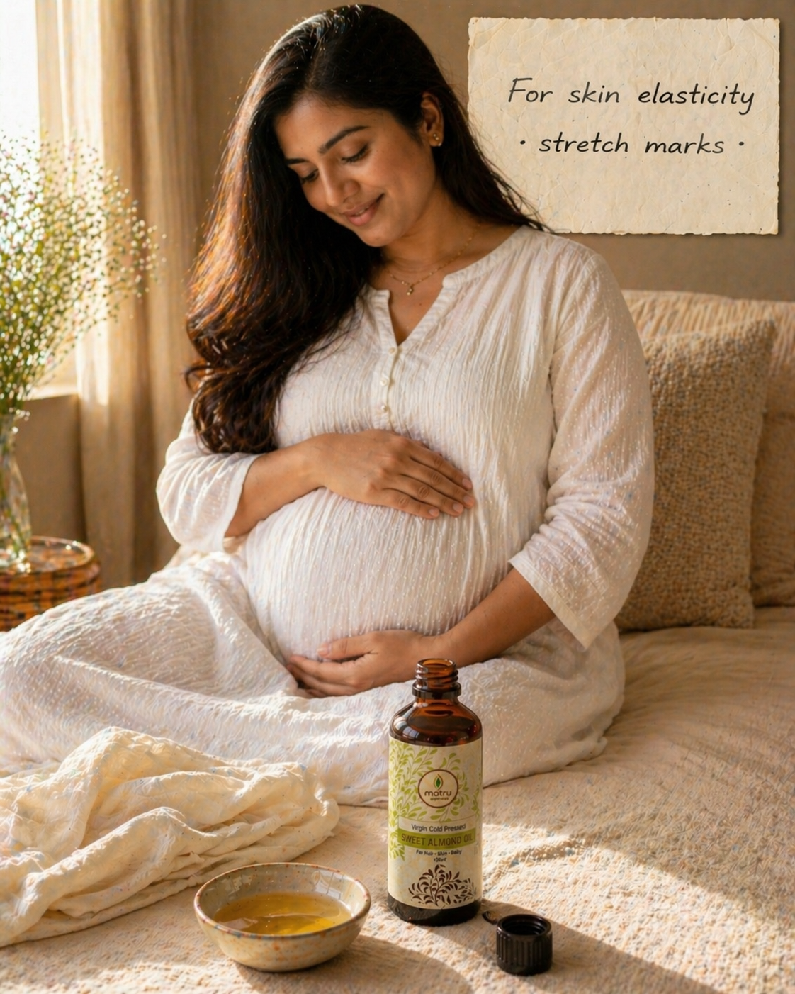 Pregnant Indian woman applying cold pressed sweet almond oil to belly for stretch marks — pure badam tel for skin elasticity during pregnancy