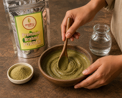 Brahmi powder being mixed with warm water into a paste in a bowl — ayurvedic hair pack recipe for hair growth and hair fall control