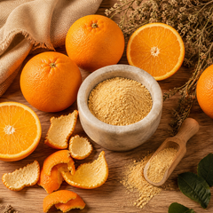 Fresh orange peels and finely ground orange peel powder in a stone mortar — natural Vitamin C source for Matru Ayurveda skincare
